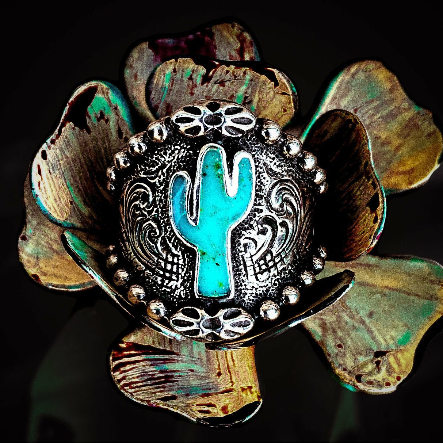 Cactus ring is a solid sterling silver ring that features a cactus in the center filled with our Turquoise Inlay. This ring has a beaded border which is complimentary to the western engraving on the rest of the ring. Even though this ring tapers in the back for a nice comfort fit and would look great wearing on any finger, we do suggest going up a half size due to thickness.