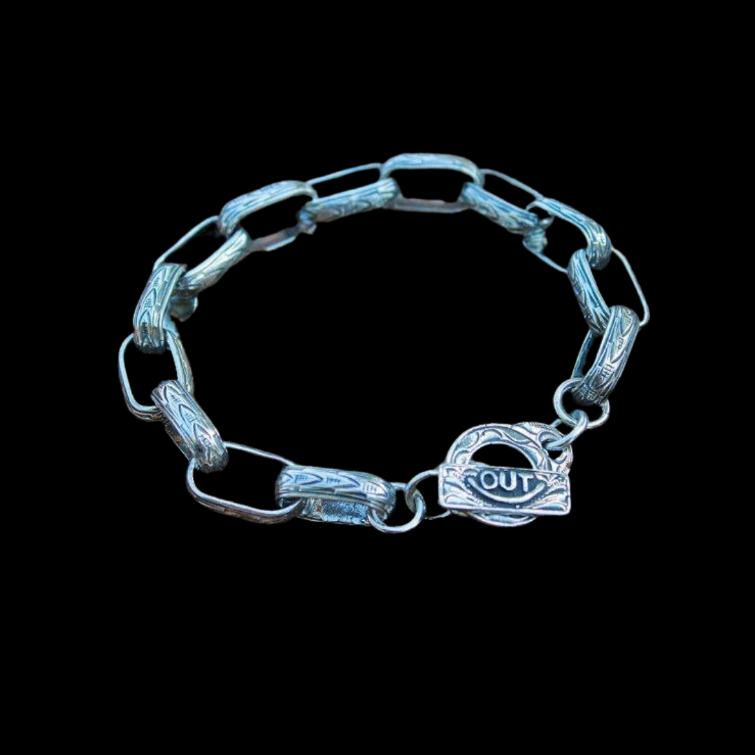 The "Chain Gang" Bracelet is a handmade which features solid sterling silver western style hand engraved links. The men's bracelet length is 9" long and the women's bracelet length is 7 1/2" long. Each link measures 5/8" long by 1/2" wide.