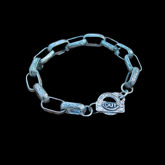 The "Chain Gang" Bracelet is a handmade which features solid sterling silver western style hand engraved links. The men's bracelet length is 9" long and the women's bracelet length is 7 1/2" long. Each link measures 5/8" long by 1/2" wide.