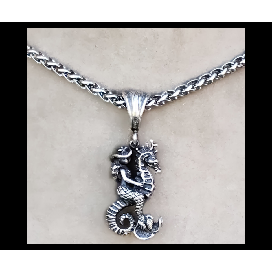 Rockin Out Jewelry's "Cowgirl Mermaid" is a solid, sterling silver 3D (detailed on front and back) pendant that features a mermaid cowgirl riding a seahorse with hair blowing in the wind, starfish hat and seashell bra on headed to conquer the world! This unique pendant measures about 1" long without the bail and about 1 3/4" with the bail.