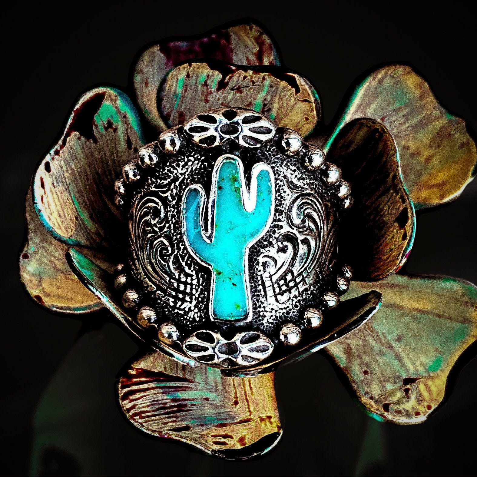 Cactus ring is a solid sterling silver ring that features a cactus in the center filled with our Turquoise Inlay. This ring has a beaded border which is complimentary to the western engraving on the rest of the ring. Even though this ring tapers in the back for a nice comfort fit and would look great wearing on any finger, we do suggest going up a half size due to thickness. 