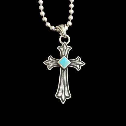 Handcrafted sterling silver pendant that features a hand engraved Celtic Cross with the center of the cross being Kingman Turquoise from the Kingman Mines from Kingman, AZ. Natural Kingman Turquoise stones may vary in color from stone to stone. 