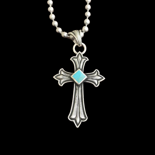 Handcrafted sterling silver pendant that features a hand engraved Celtic Cross with the center of the cross being Kingman Turquoise from the Kingman Mines from Kingman, AZ. Natural Kingman Turquoise stones may vary in color from stone to stone.