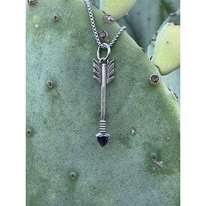 The "Dream Chaser" is a custom sterling silver pendant that has a unique and beautiful  arrow shape that features a 7mm turquoise or black stone as the tip of the arrow. This pendant measures at approximately 2" long.