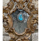 Custom sterling silver pendant set with a hand cut Smoky Kingman turquoise stone surrounded by a roped border and parachute dots finished with a beautiful antiquing. This is a gorgeous piece. The bail gives this entire piece character as it set with a small round smoky Kingman stone in the center! Measures 3x1.5” and comes on a 24” wheat chain! 