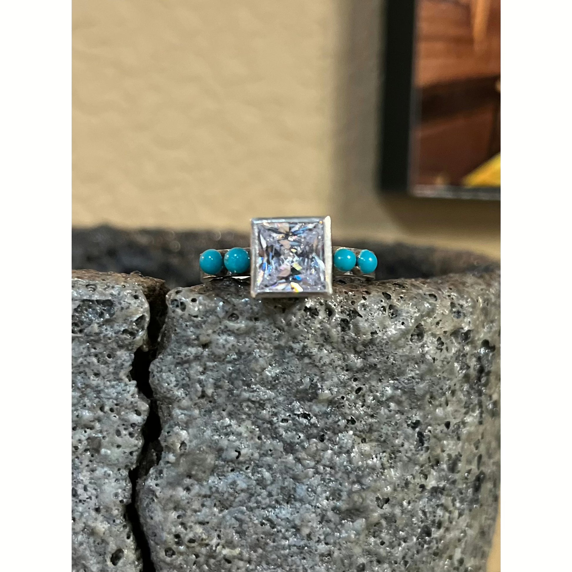 Rockin' Out's Kora is very similar to our Koriel except it has more of a western style!  Featuring an 8mm square Cubic Zirconium Stone with turquoise inlay on each side of the stone.