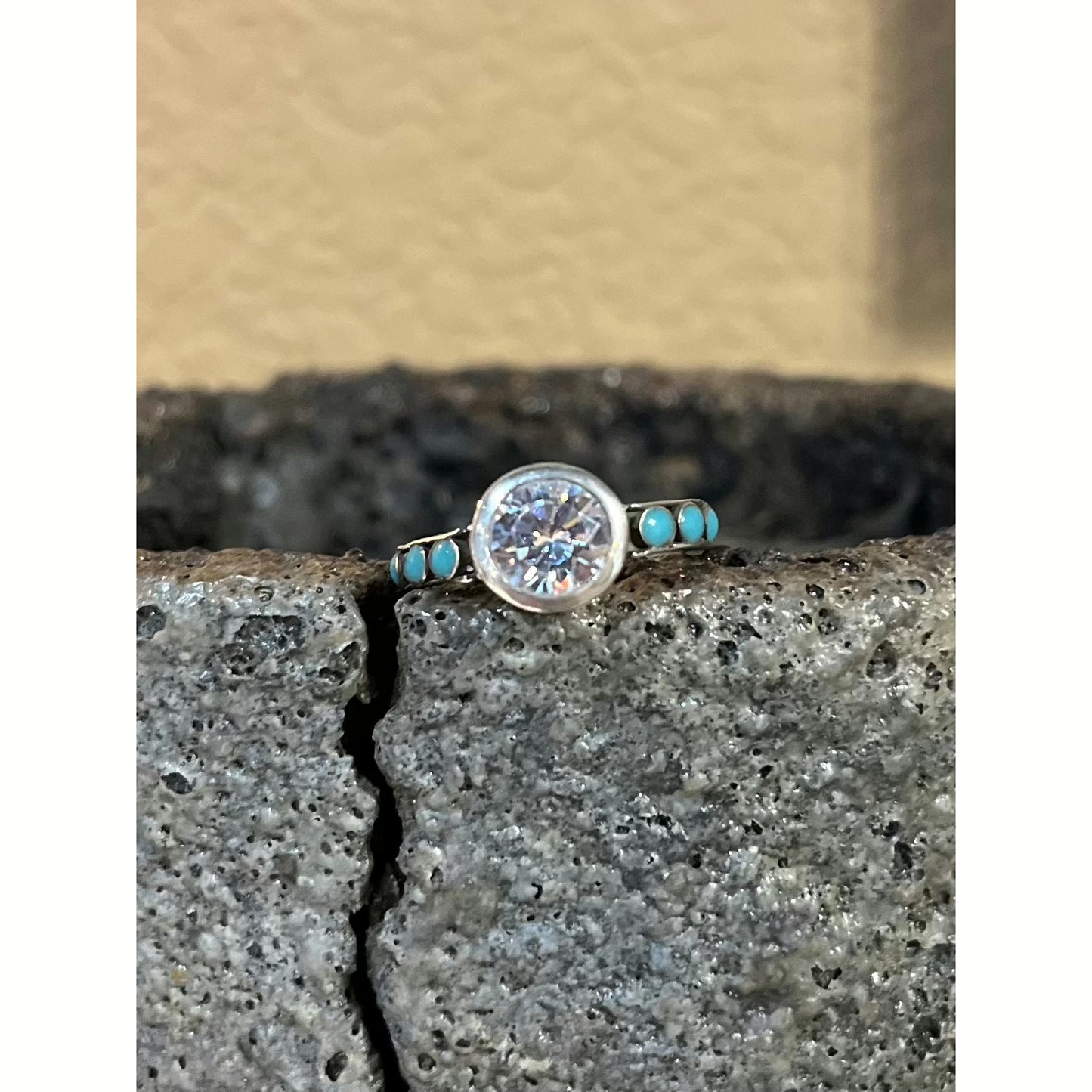 Rockin Out Jewelry’s “Kora” is solid sterling ring that features an elegant 8mm round cz stone in the center accented with 2 settings on each side filled with our turquoise inlay.
