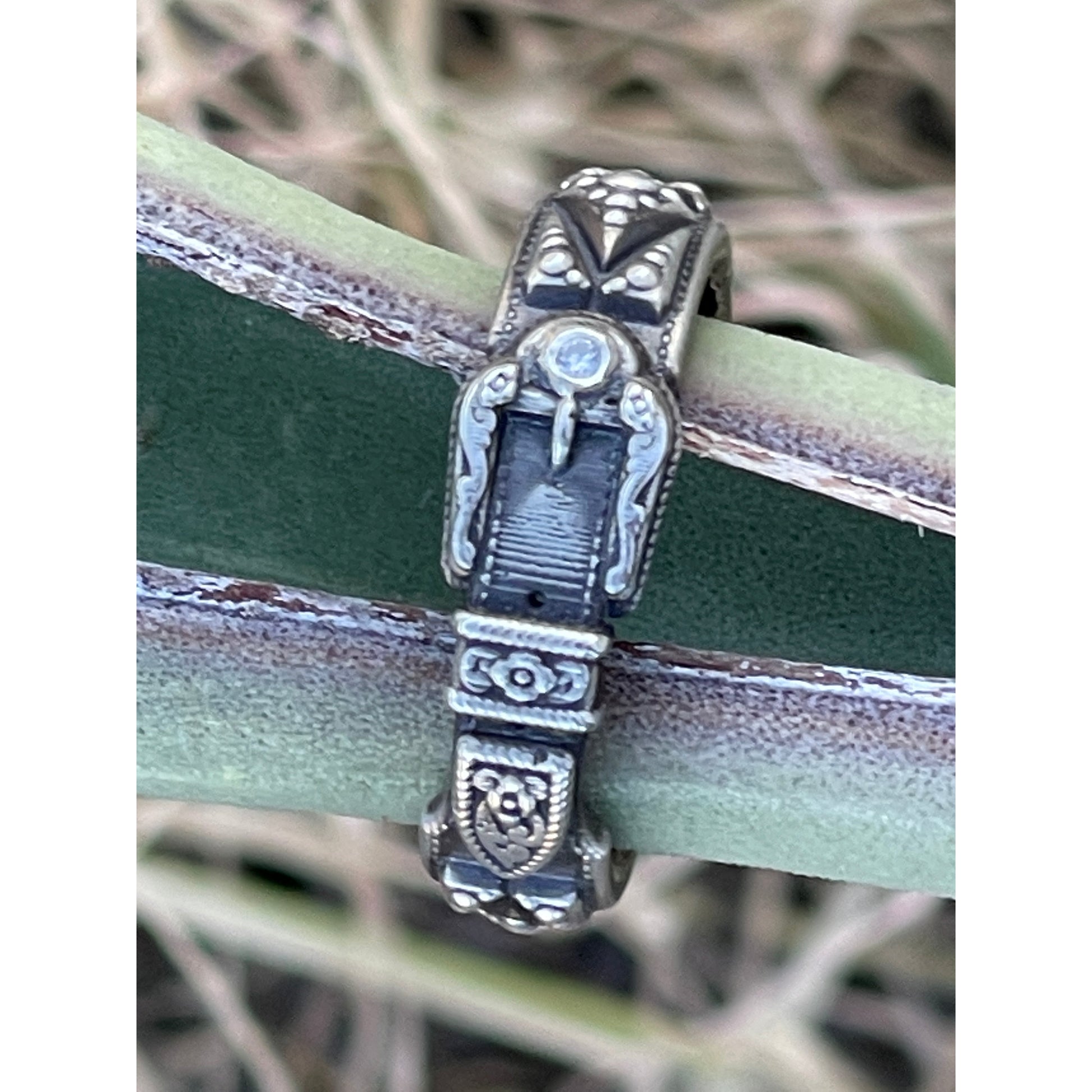 handcrafted sterling silver ring complimented by a cubic zirconia stone which has been set on the buckle end of the ring. The Buckle ring is just gorgeous and can be worn on any finger it also pairs beautifully with our bands. Very detailed and finished off with antiquing which just makes this ring pop!
