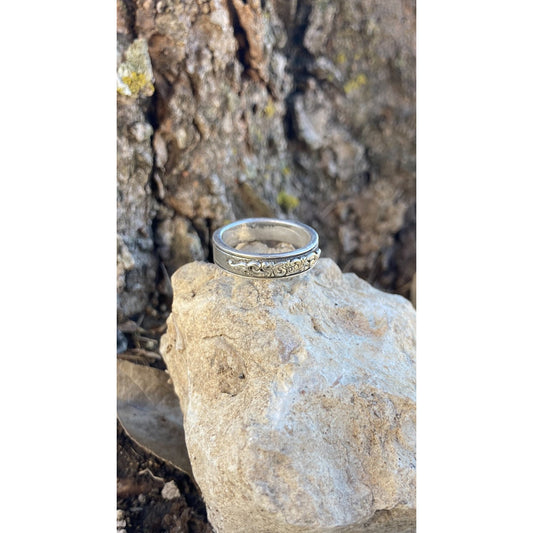 Handmade sterling silver band with a western style scroll overlay on band.