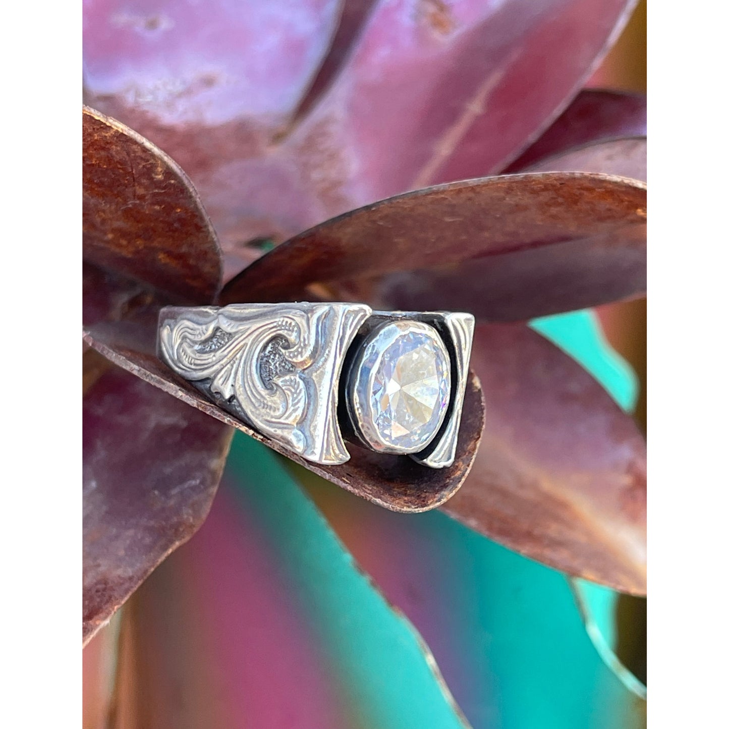  beautiful heavy sterling silver cathedral ring with overlaid bank note scrolls on each side of the ring with a 8mm x 10mm bezel set cubic zirconia.   
