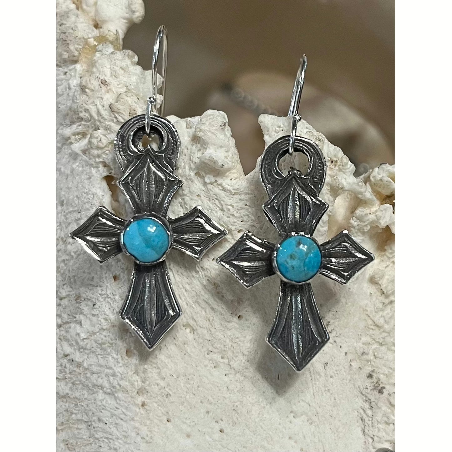 The "Lil Sprit" handmade Cross Earrings are small sterling silver cross dangle earrings that feature a round bezel set Genuine Kingman Turquoise Stone from the Kingman Mines in Kingman, AZ. Measures at 3/4" X 1 1/4".  