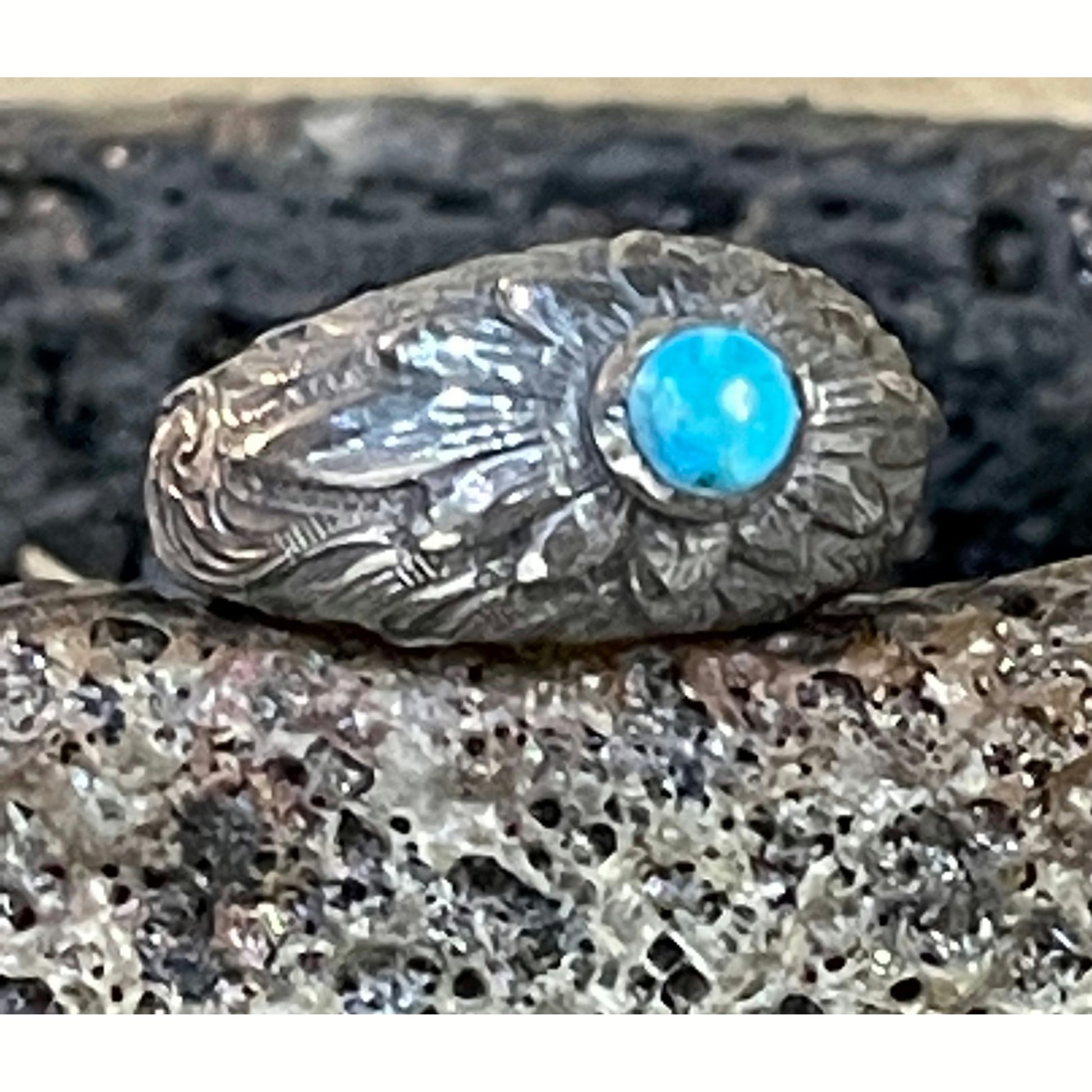 "Madre" is a handmade sterling silver ring that features a high dome with an overlaid hand engraved flower with the center of the flower being a turquoise stone! 