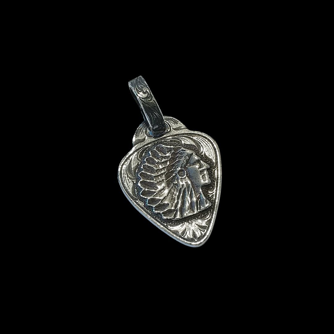 Rockin Out Jewelry's "Indian Head Guitar Pick" Necklace is custom solid sterling silver pendant that is in the shape of a guitar pick and features a western style hand engraved scrolling with an overlaid Indian Head. It measures at 1 1/8" x 1 1/2".