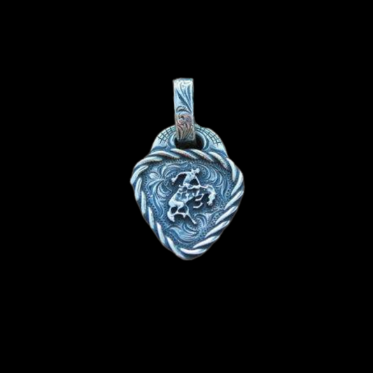 The "Keystone Guitar Pick" pendant is a handmade solid sterling silver pendant in the shape of a guitar pick with a roped edge border that surrounds the western style scrolled hand engraving as the background with a bucking horse overlay in the center of the pendant.