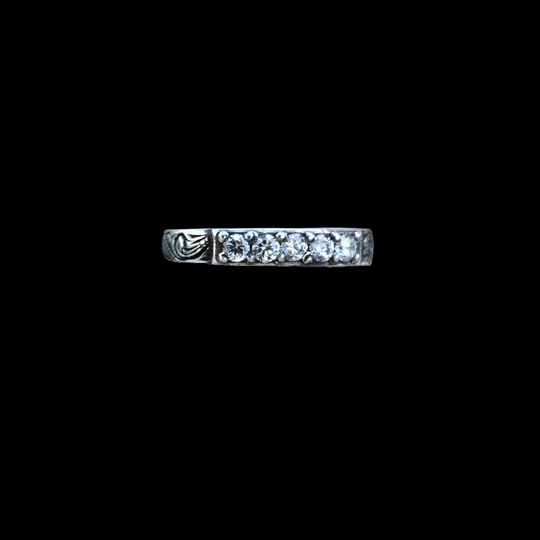The Mariah band is a handmade comfort fit band that features a total of 5 round 2.5mm CZ stones in the center that accent the western style hand engraving on both sides.