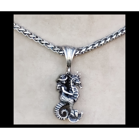 Rockin Out Jewelry's "Cowgirl Mermaid" is a solid, sterling silver 3D (detailed on front and back) pendant that features a mermaid cowgirl riding a seahorse with hair blowing in the wind, starfish hat and seashell bra on headed to conquer the world! This unique pendant measures about 1" long without the bail and about 1 3/4" with the bail. 